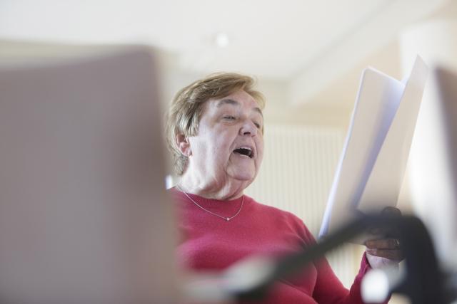 an elderly woman singing 