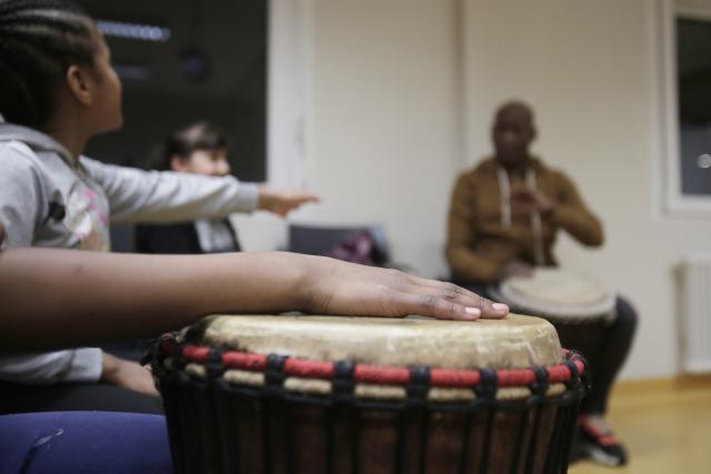 Child playing djembe