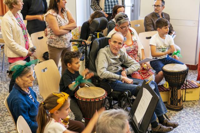 Des personnes âgées et des enfants jouant des percussions ensemble