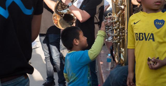 Un enfant touchant un instrument en souriant