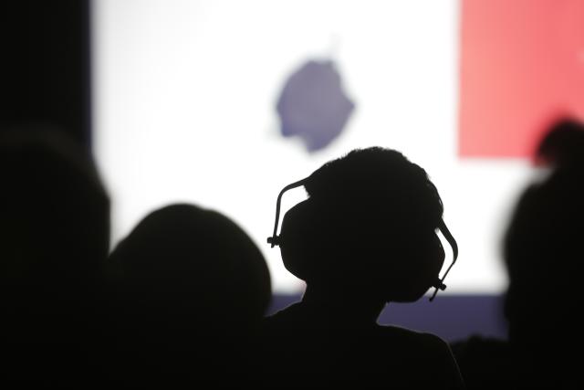 child wearing headphones watching a show