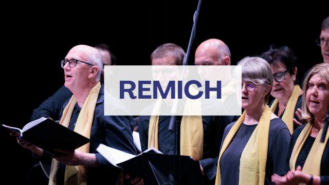 People singing and a word saying "Remich".